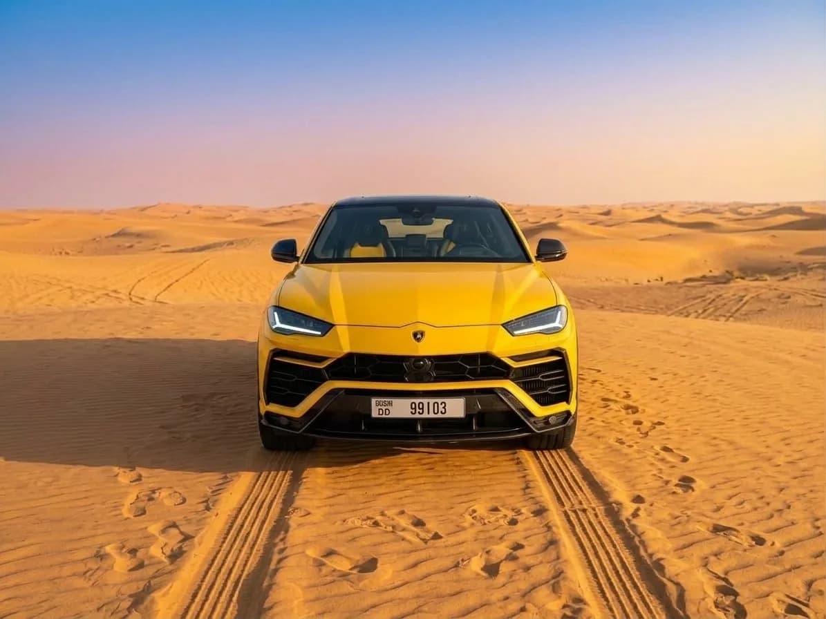 Yellow Lamborghini Urus 2021 front view in the Dubai desert